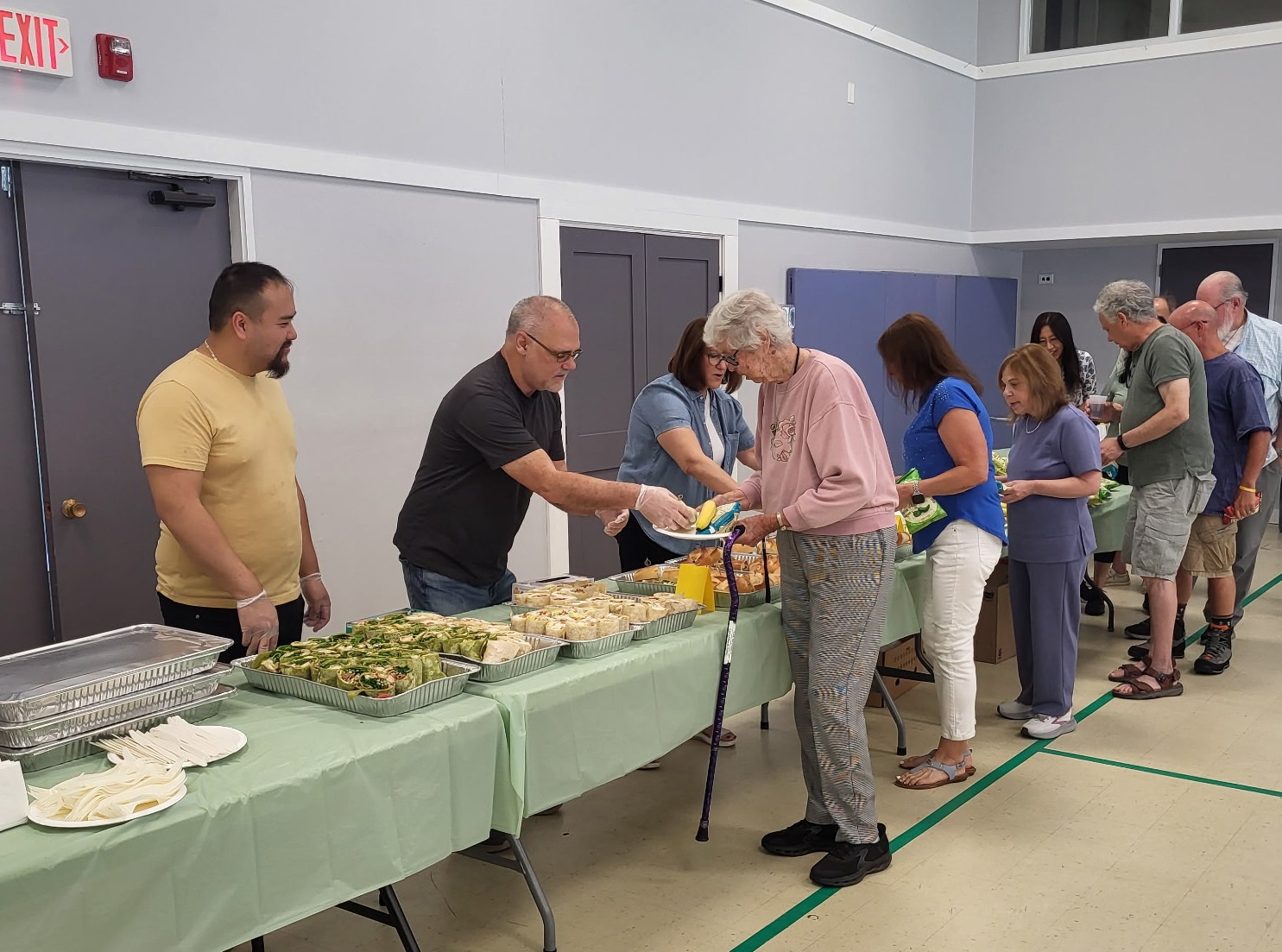 Marty Mygan serving food at a senior lunch
